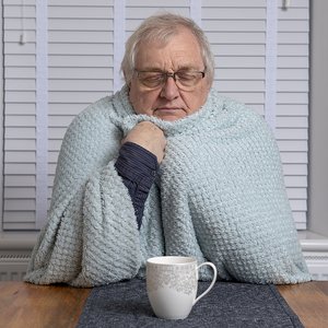 bigstock-Cold-Senior-Man-Sitting-With-H-444654641.jpg