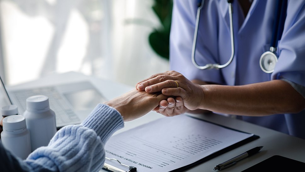 bigstock-Elderly-Doctor-And-Patient-Sit-468855983.jpg