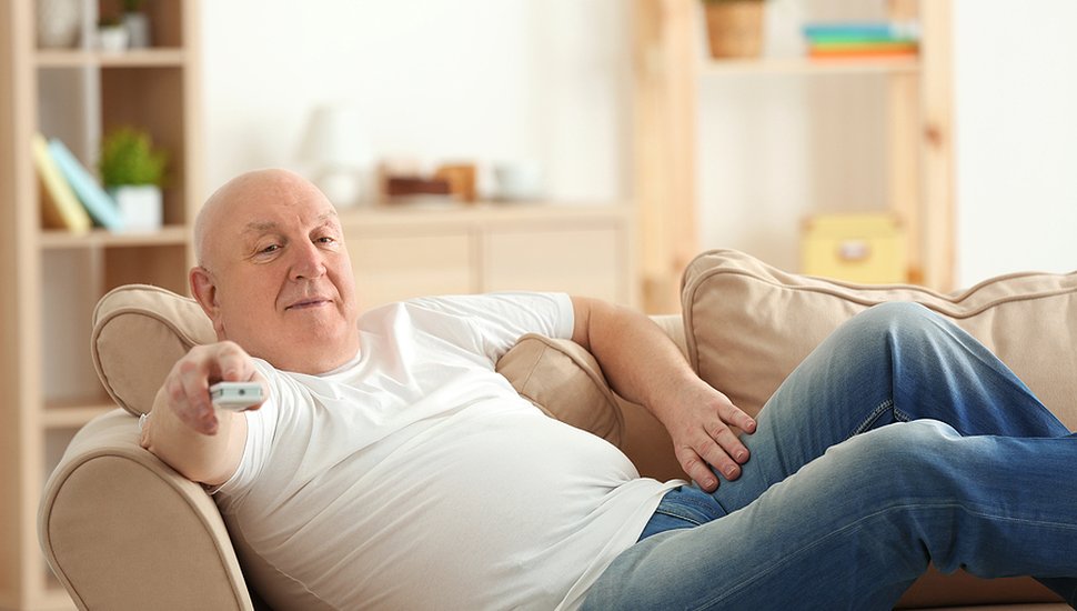 bigstock-Fat-senior-man-watching-TV-whi-191930461.jpg